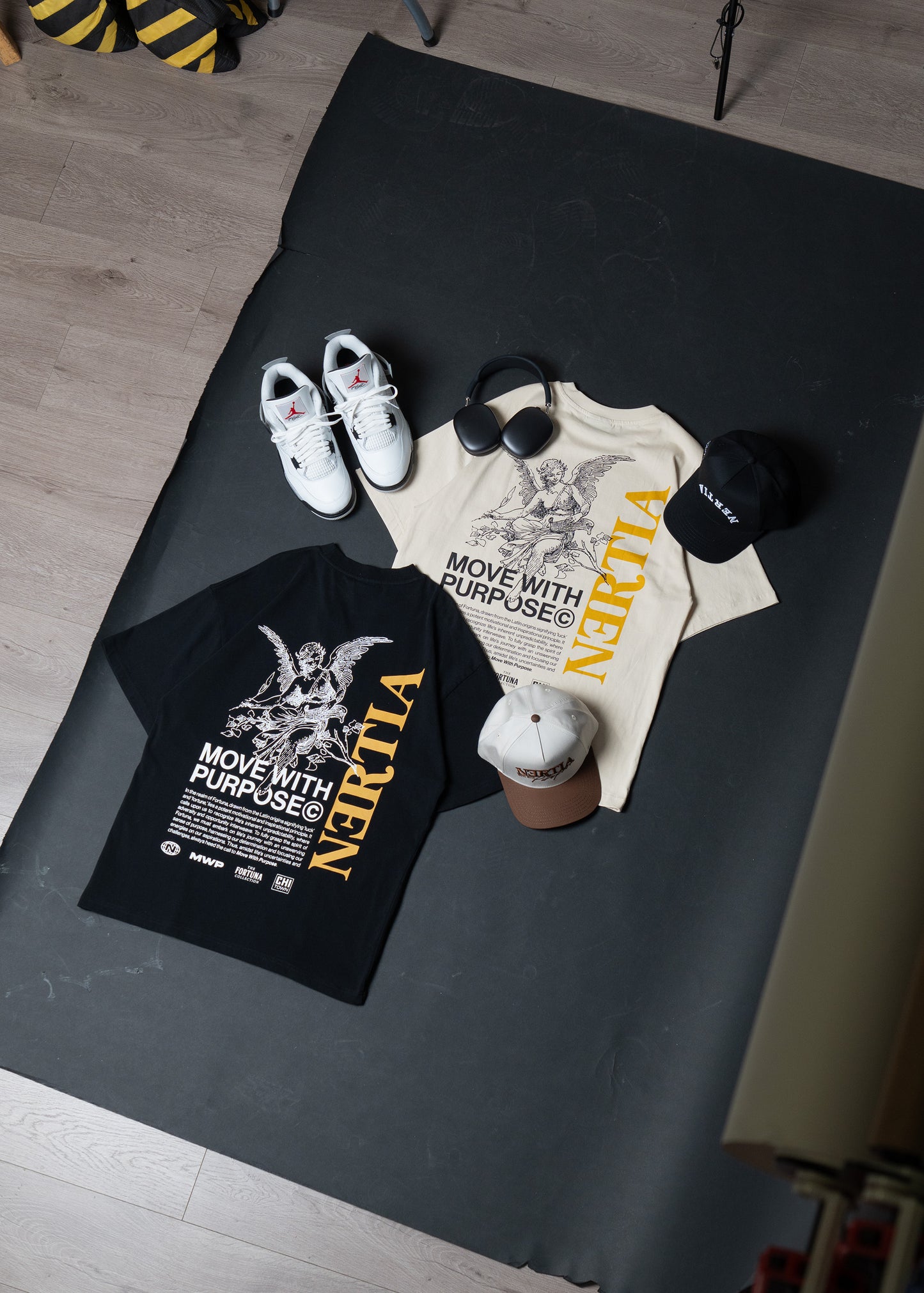 Black and white t-shirts with 'Narita' branding on a black surface.