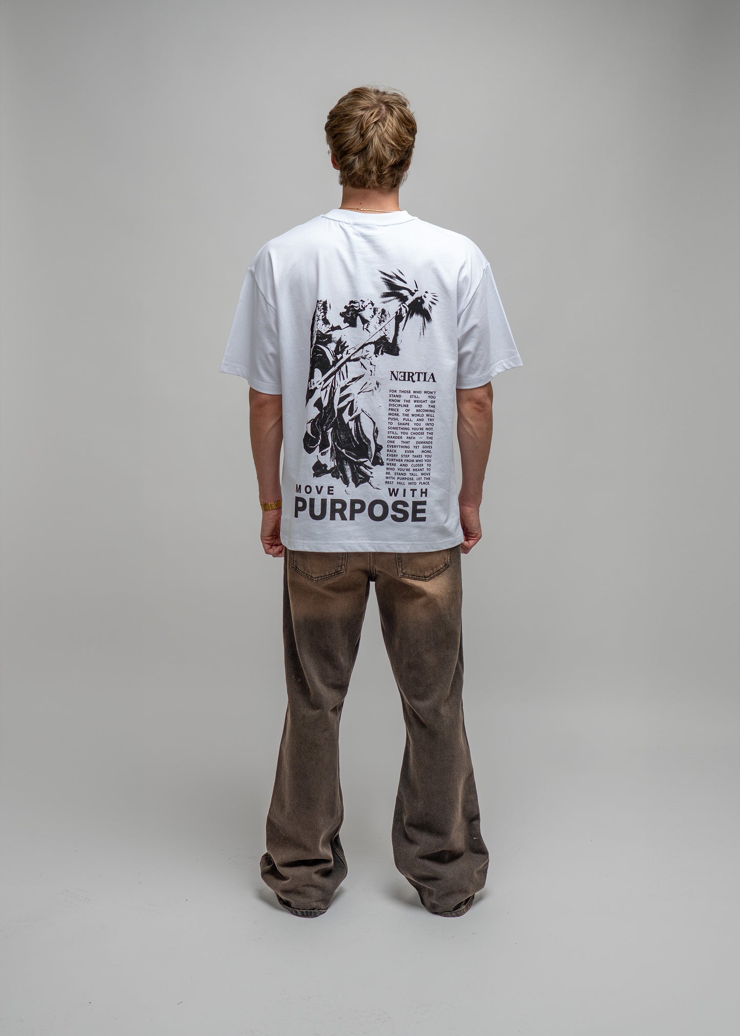 Person wearing a white t-shirt with black graphics and text on a plain background