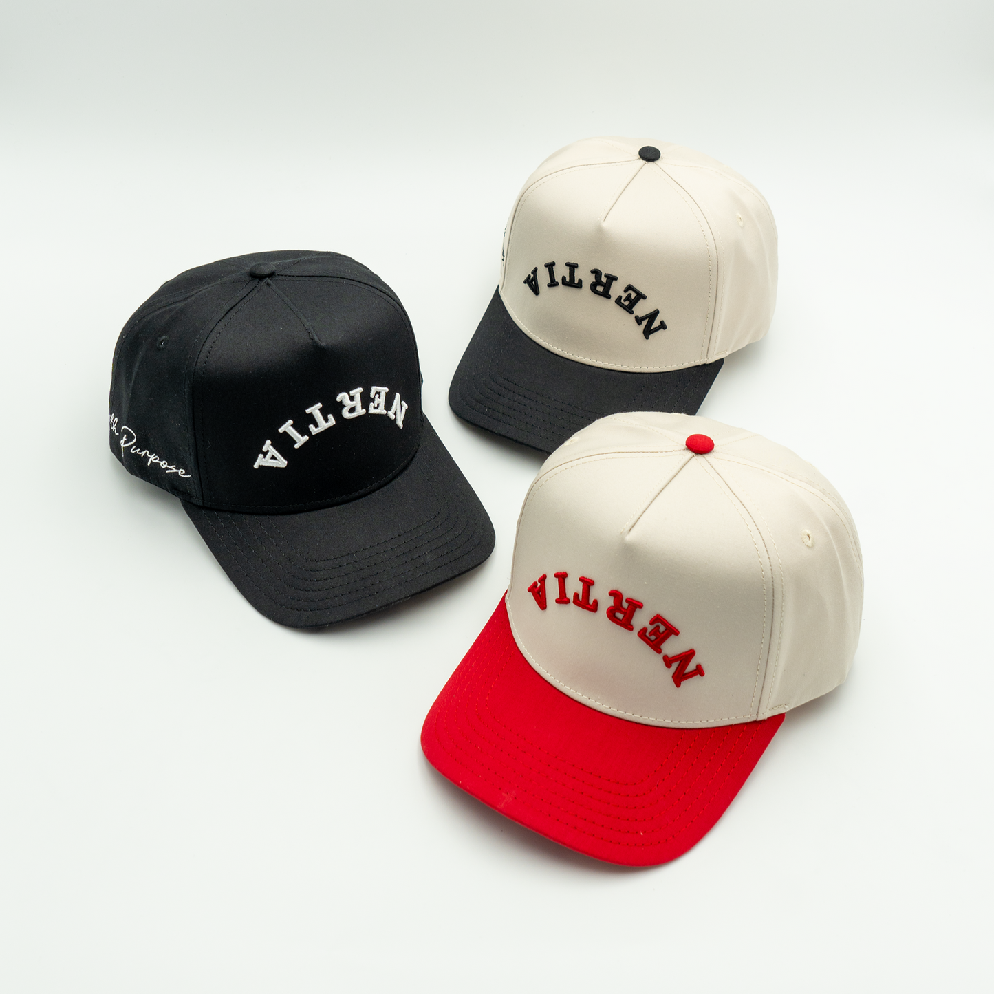 Three baseball caps in black, beige, and red with 'Nevian' branding on a white background.