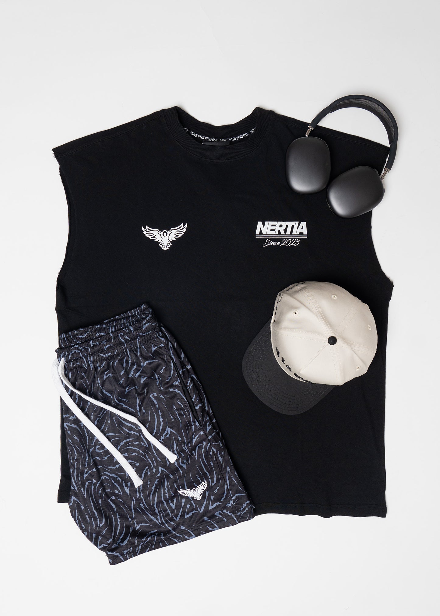 Black sleeveless shirt with NERTIA logo, patterned shorts, white ball, and black weight on a light gray background