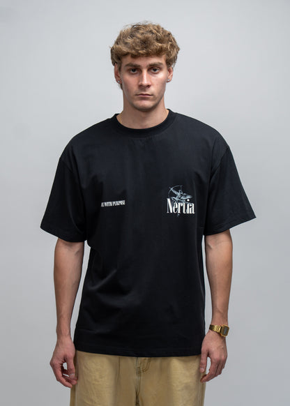 Person wearing a black t-shirt with a logo on a gray background