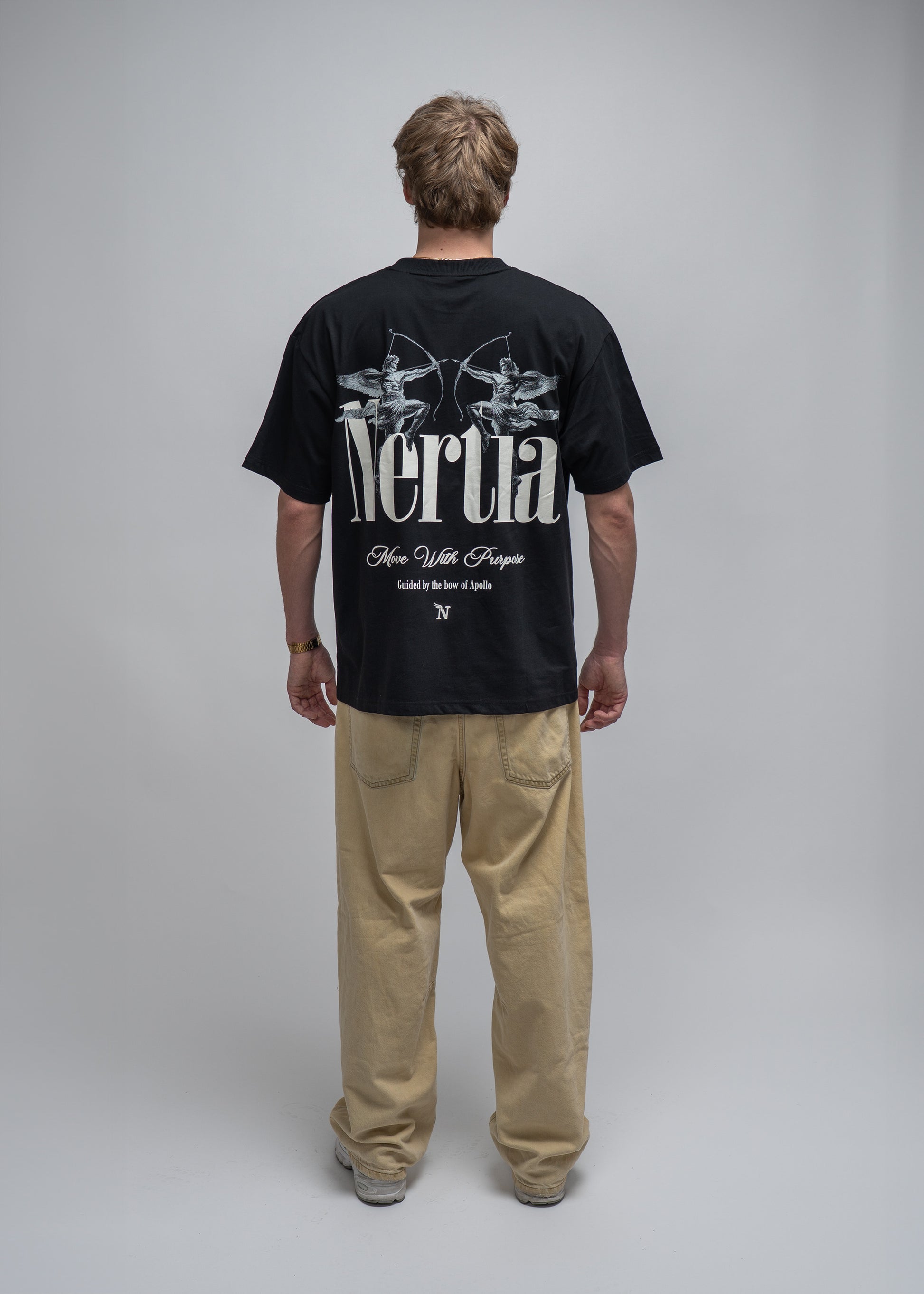 Person wearing a black t-shirt with 'Nertia' branding on a plain background
