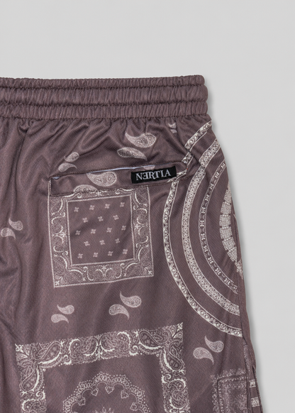 Brown shorts with bandana pattern and visible brand label on a light gray background