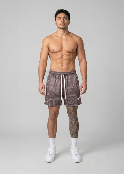 Man wearing patterned shorts on a plain background