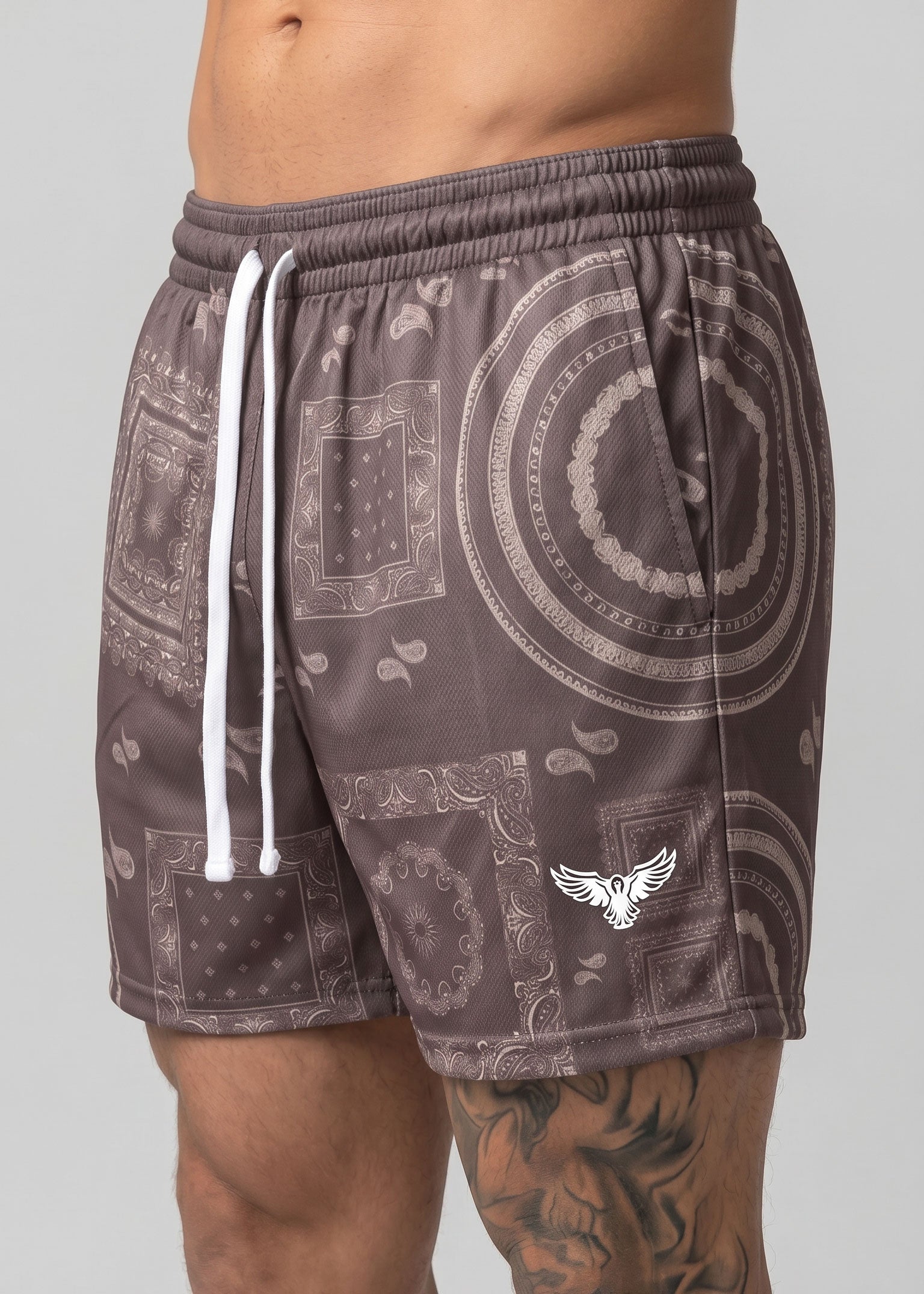 Patterned shorts with a visible brand logo on a gray background