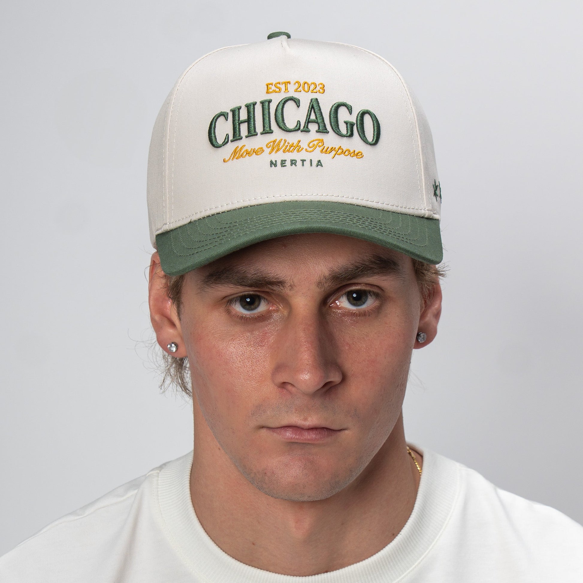 Person wearing a cap with 'Chicago' text on a plain background