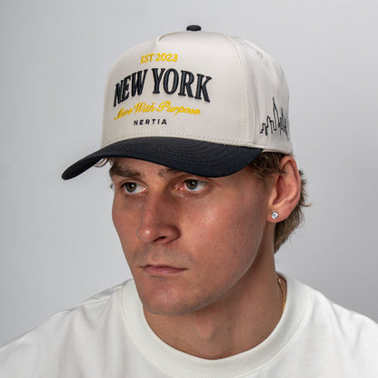 Man wearing a white cap with 'New York' text against a gray background