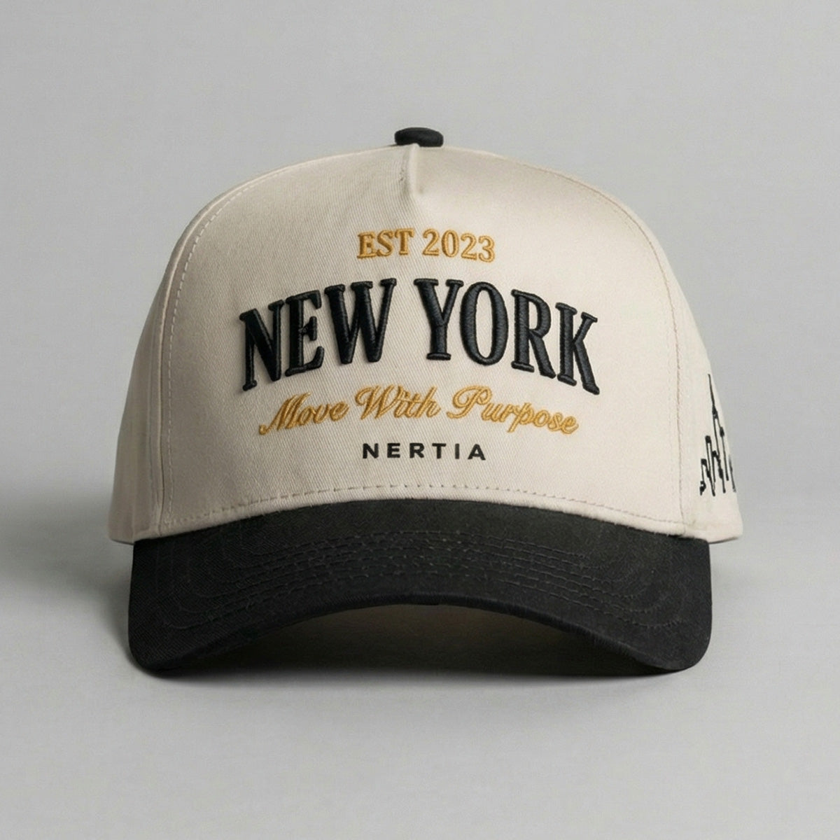 Beige and black cap with 'New York' and 'Nertia' text on a gray background