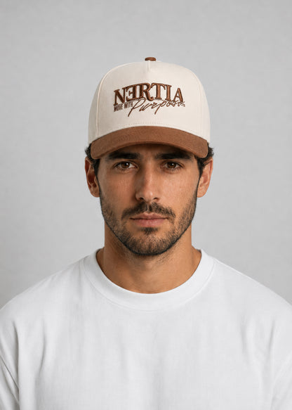Man wearing a beige cap with brown text on a gray background