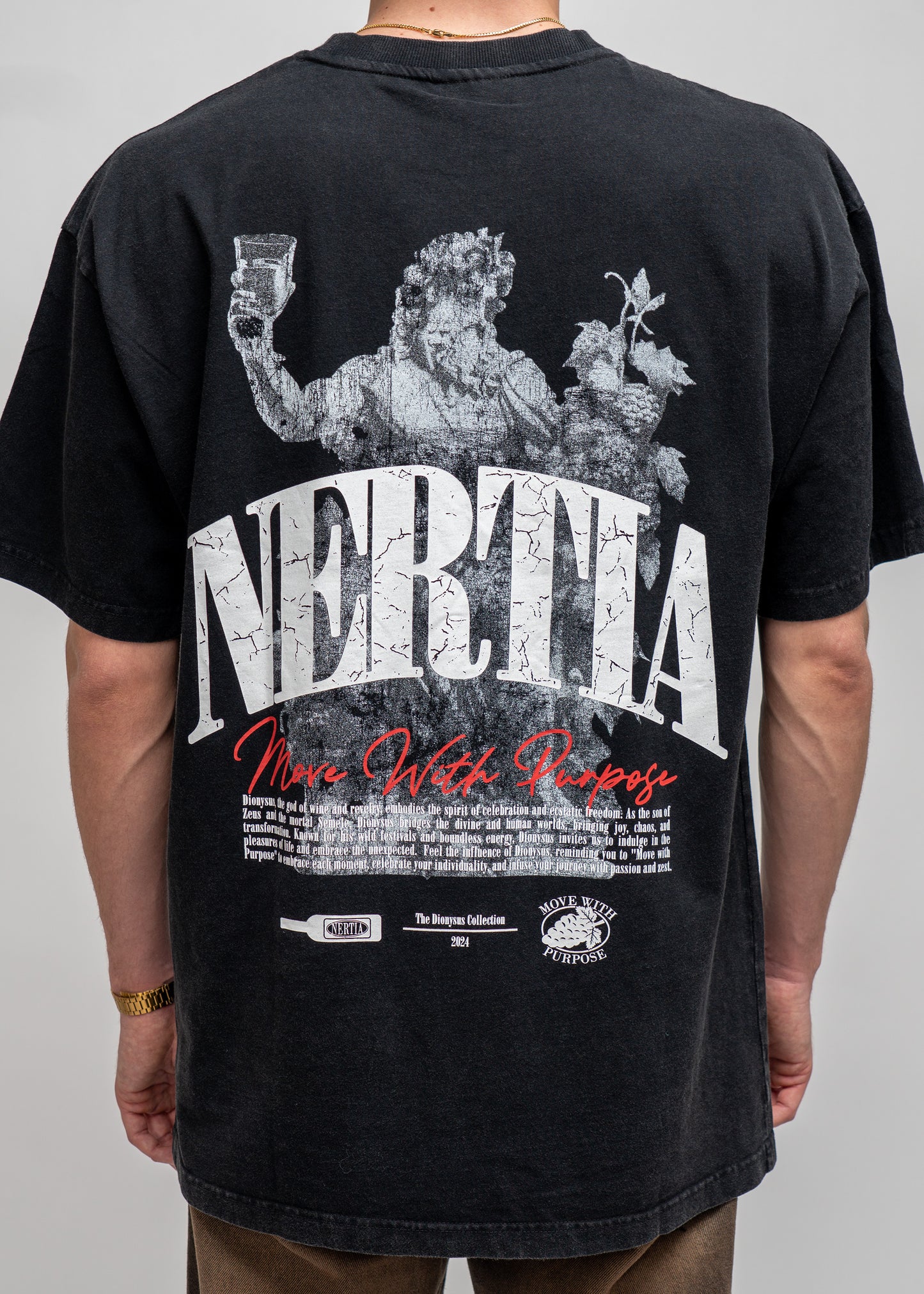 Black t-shirt with graphic design and text on the back, worn by a person.