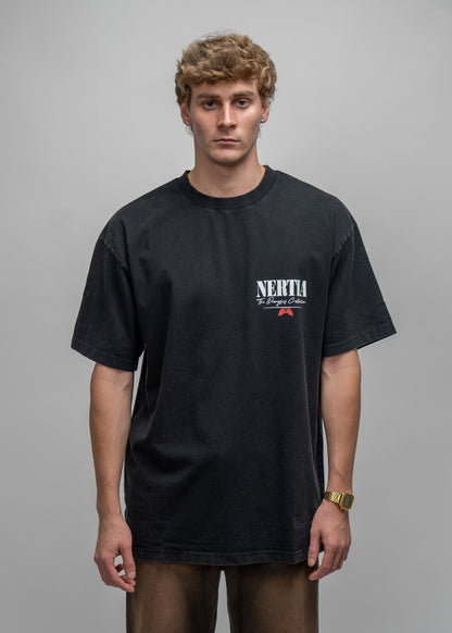 Man wearing a black t-shirt with a logo on a gray background