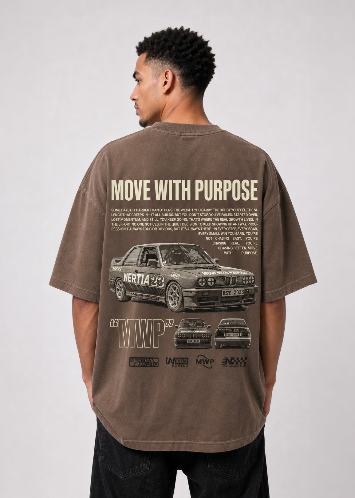 Person wearing a brown t-shirt with car graphics and text on the back