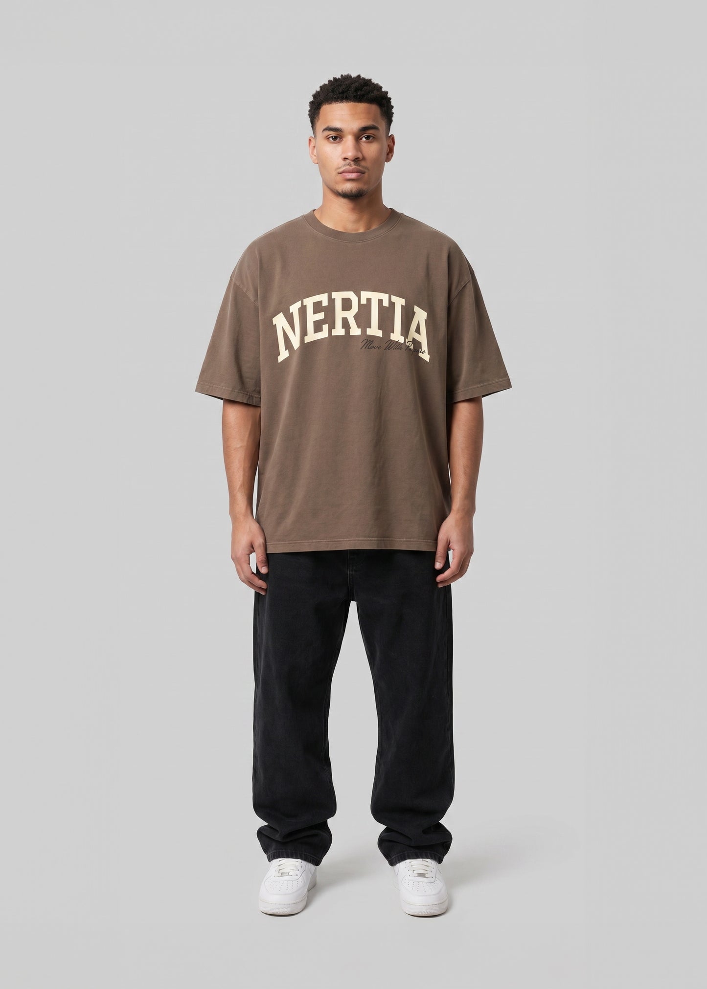 Person wearing a brown 'Nertia' t-shirt on a gray background