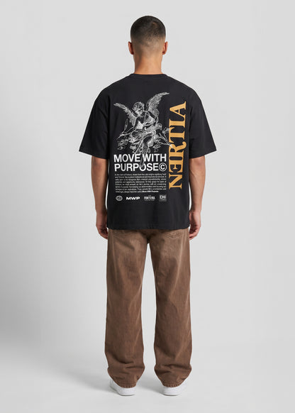Person wearing a black t-shirt with text and graphics on the back, standing against a plain background