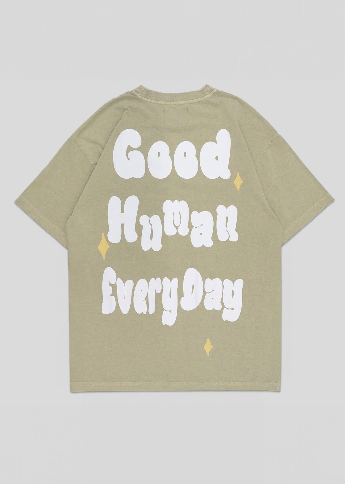 Beige t-shirt with 'Good Human Every Day' text on a light gray background