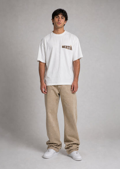 Person wearing a white t-shirt with text and beige pants on a gray background