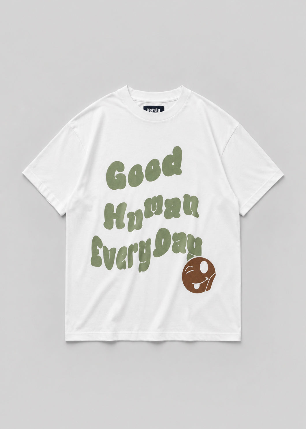 White t-shirt with 'Good Human Every Day' text and graphic on a gray background