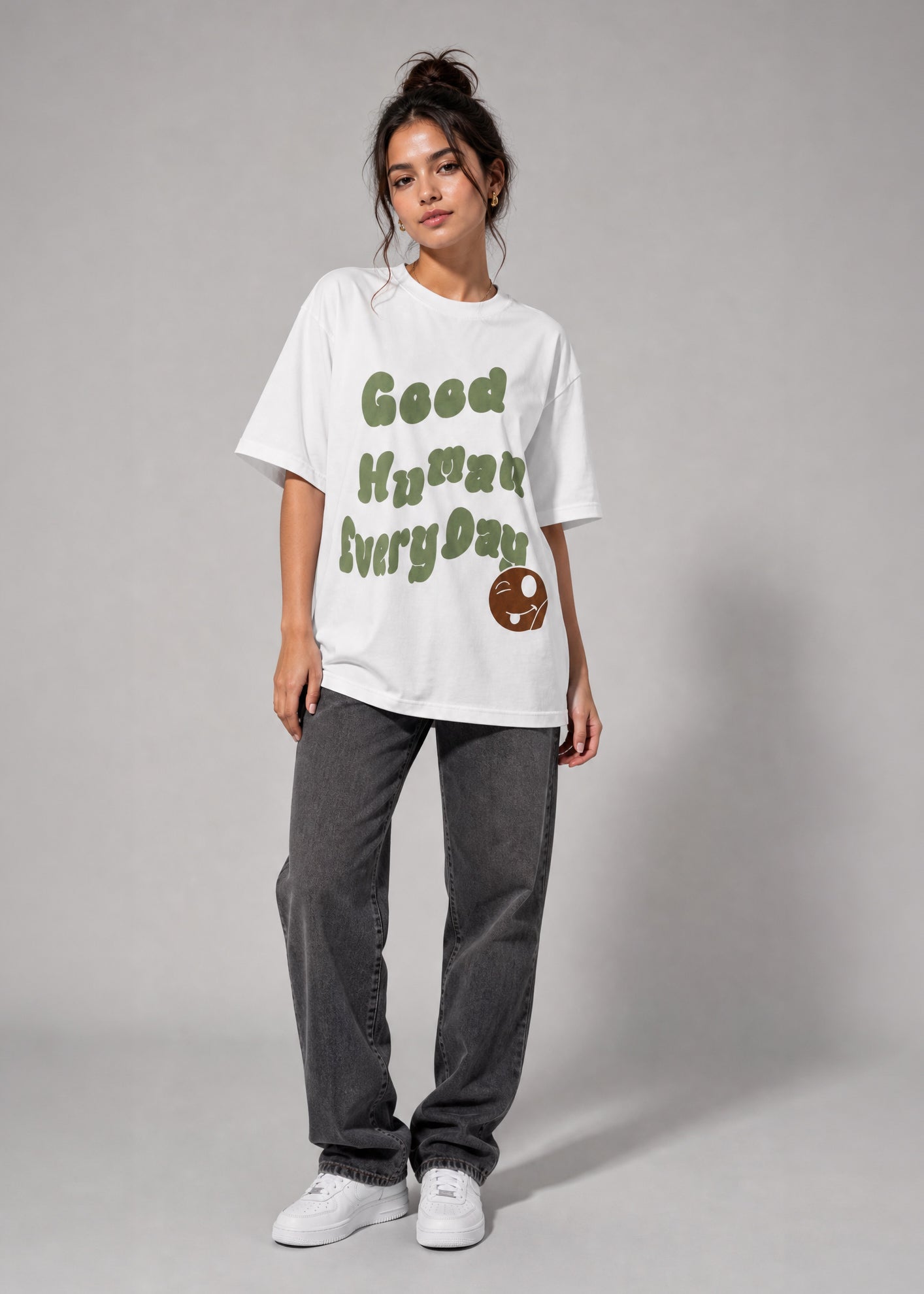 Person wearing a white t-shirt with text and graphics on a gray background