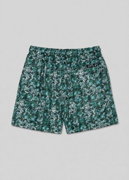 Green floral-patterned shorts on a gray background