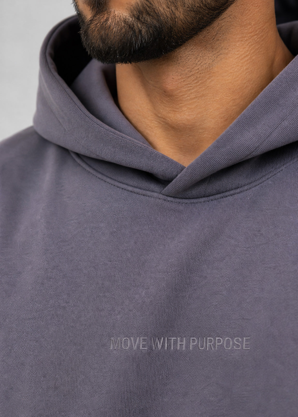 Gray hoodie with 'Move with Purpose' text on a plain background