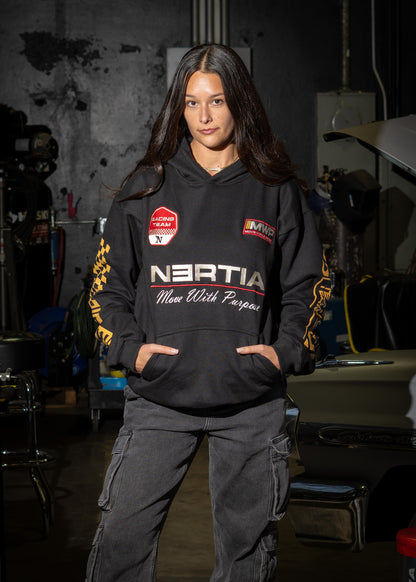 Person wearing a hoodie with NERTIA branding in a workshop setting