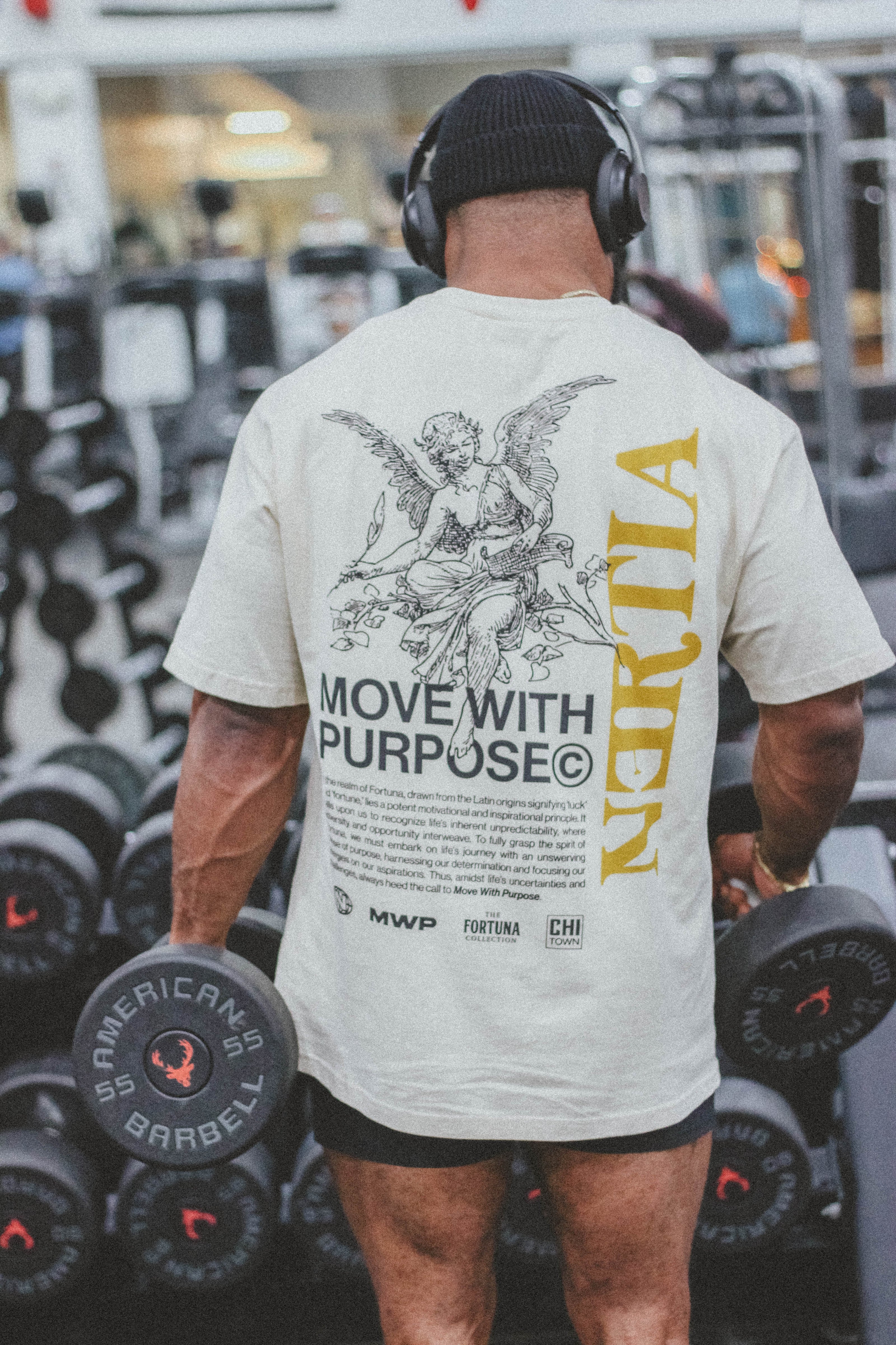 Person in a gym wearing a t-shirt with 'Move with Purpose' and 'Nerilia' branding.