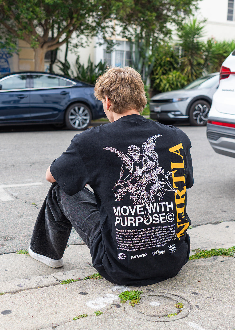 Guy Sitting Down Wearing Fortuna Shirt