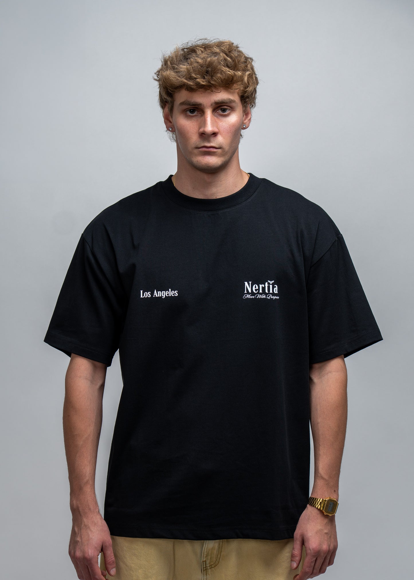 Person wearing a black t-shirt with 'Los Angeles' and 'Nerf' logos on a gray background