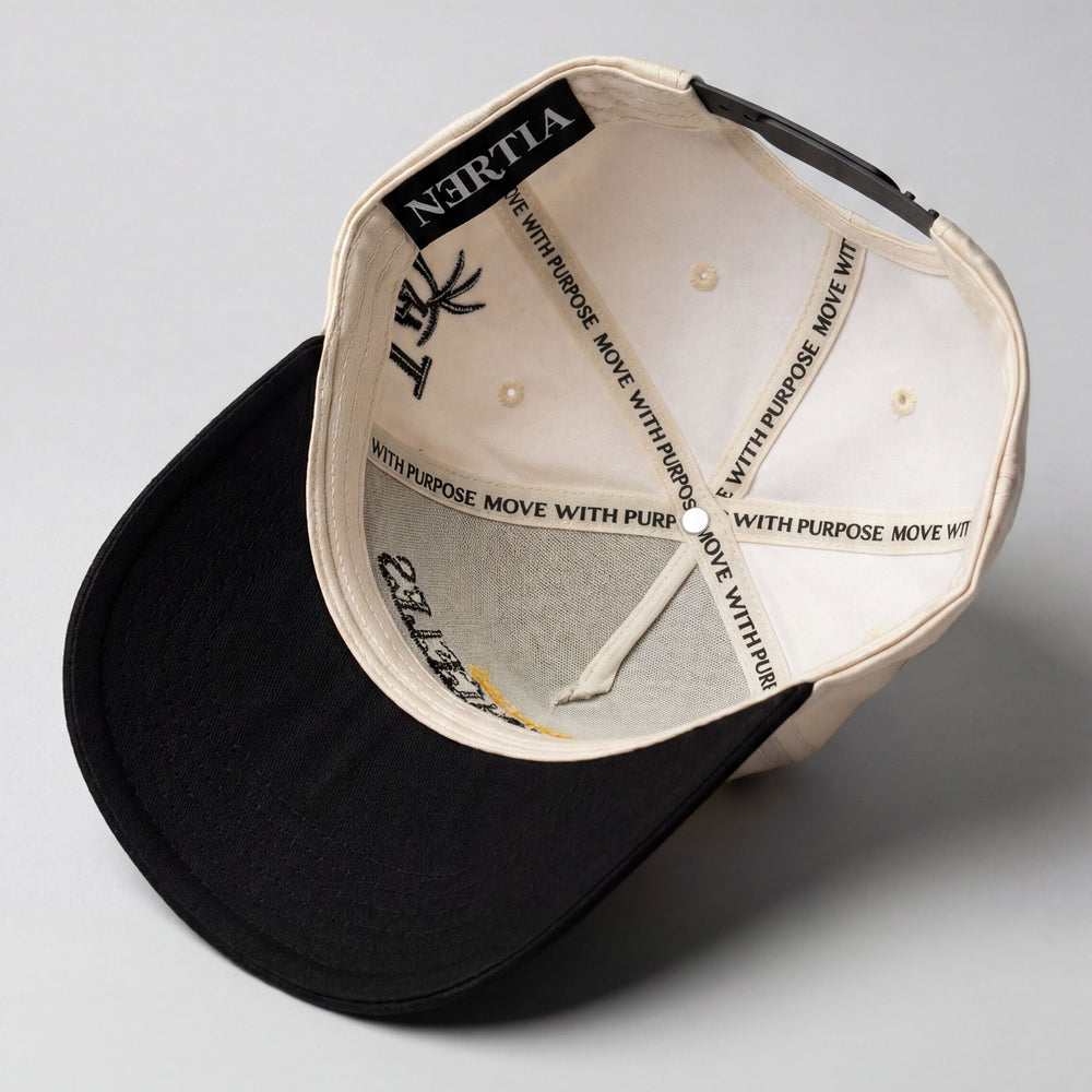 A black and off-white structured baseball cap shown from an overhead angle, revealing the interior branding with 'WITH PURPOSE' and 'MOVE WITH PURPOSE' printed repeatedly on the brim and crown.