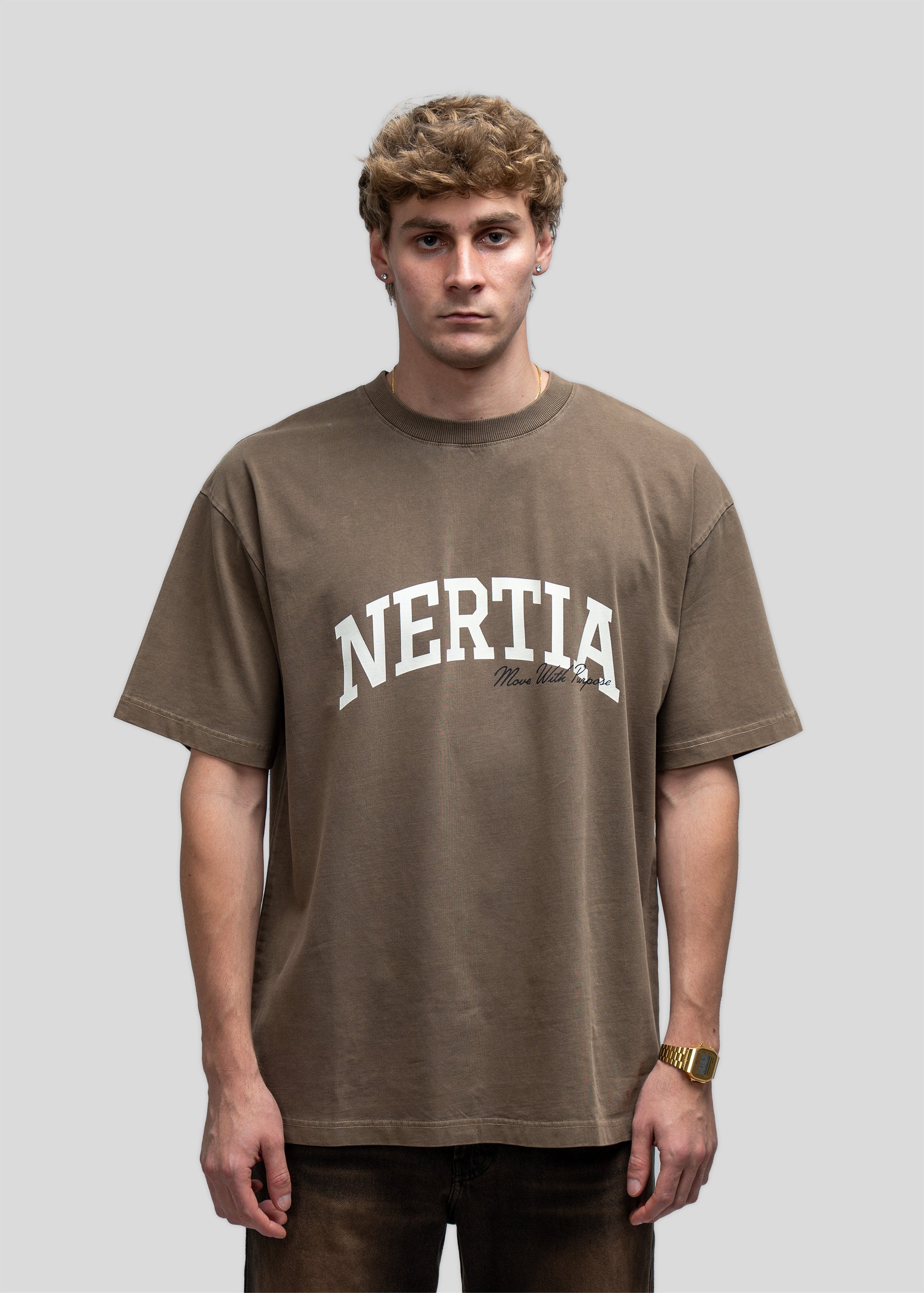 Man wearing a brown 'Nertia' t-shirt against a gray background