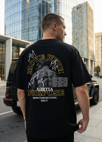 Man wearing a black t-shirt with a graphic design in an urban setting