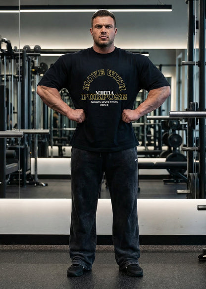 Man wearing a black t-shirt with visible branding in a gym setting
