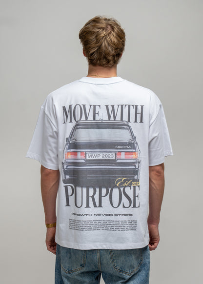 Person wearing a white t-shirt with a graphic and text on the back, standing against a plain background.