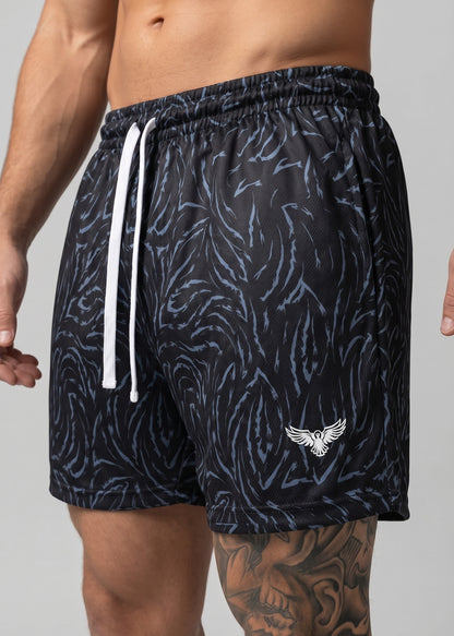 Black patterned shorts with a white drawstring and logo on a gray background