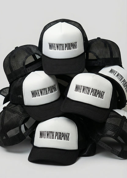 Black and white trucker hats with 'Move with Purpose' text on a light gray background