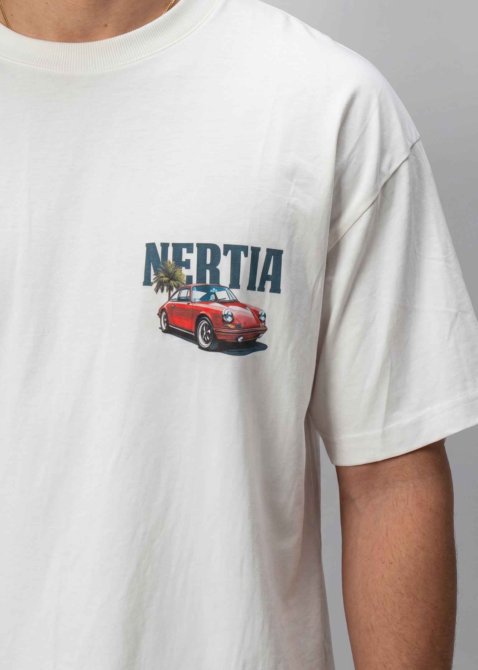 White t-shirt with a red car graphic and 'Nertia' text on a gray background