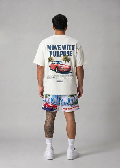 Person wearing a white t-shirt and patterned shorts with car and palm tree design on a gray background