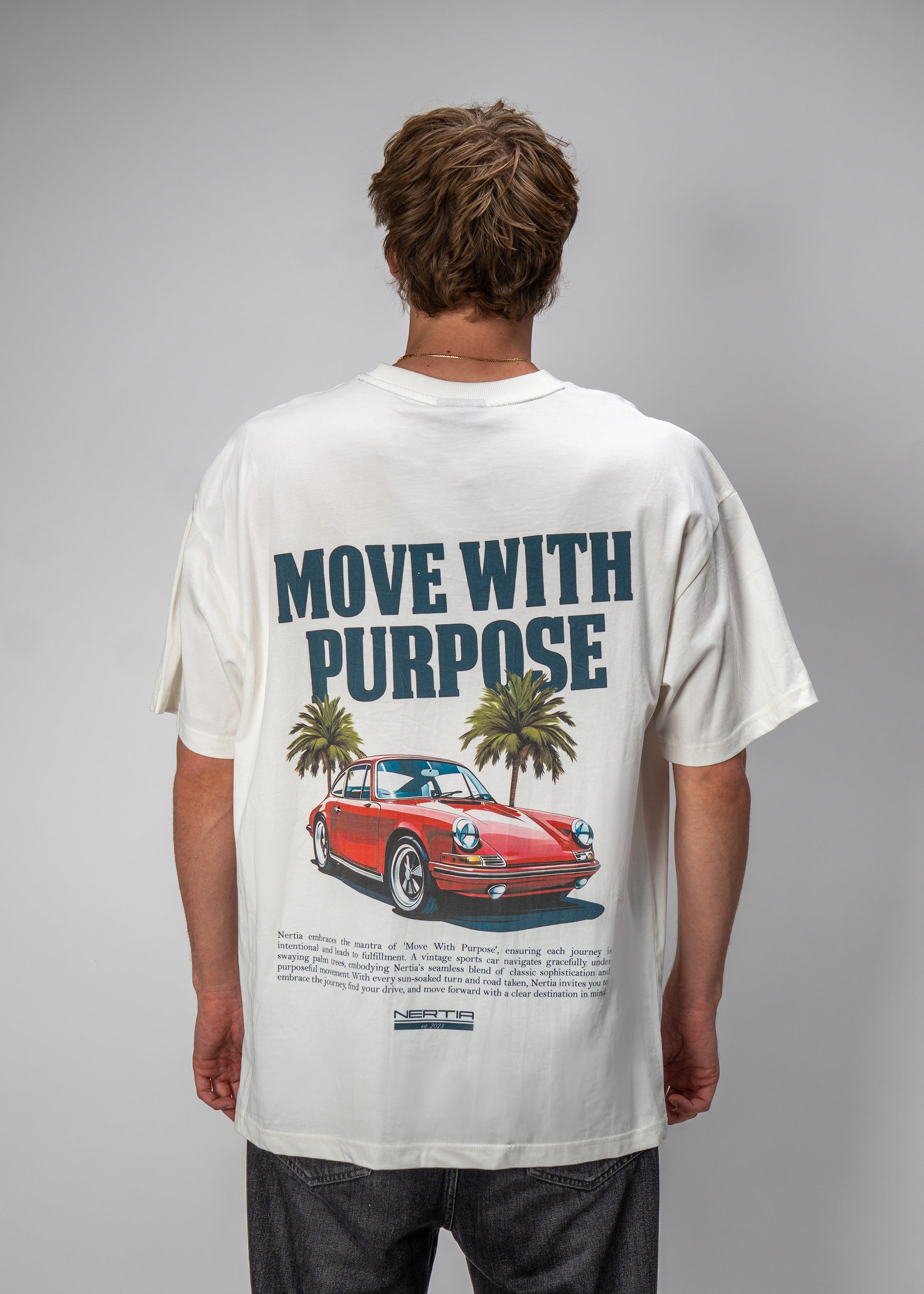 Person wearing a t-shirt with a graphic and text 'Move with Purpose' on a gray background